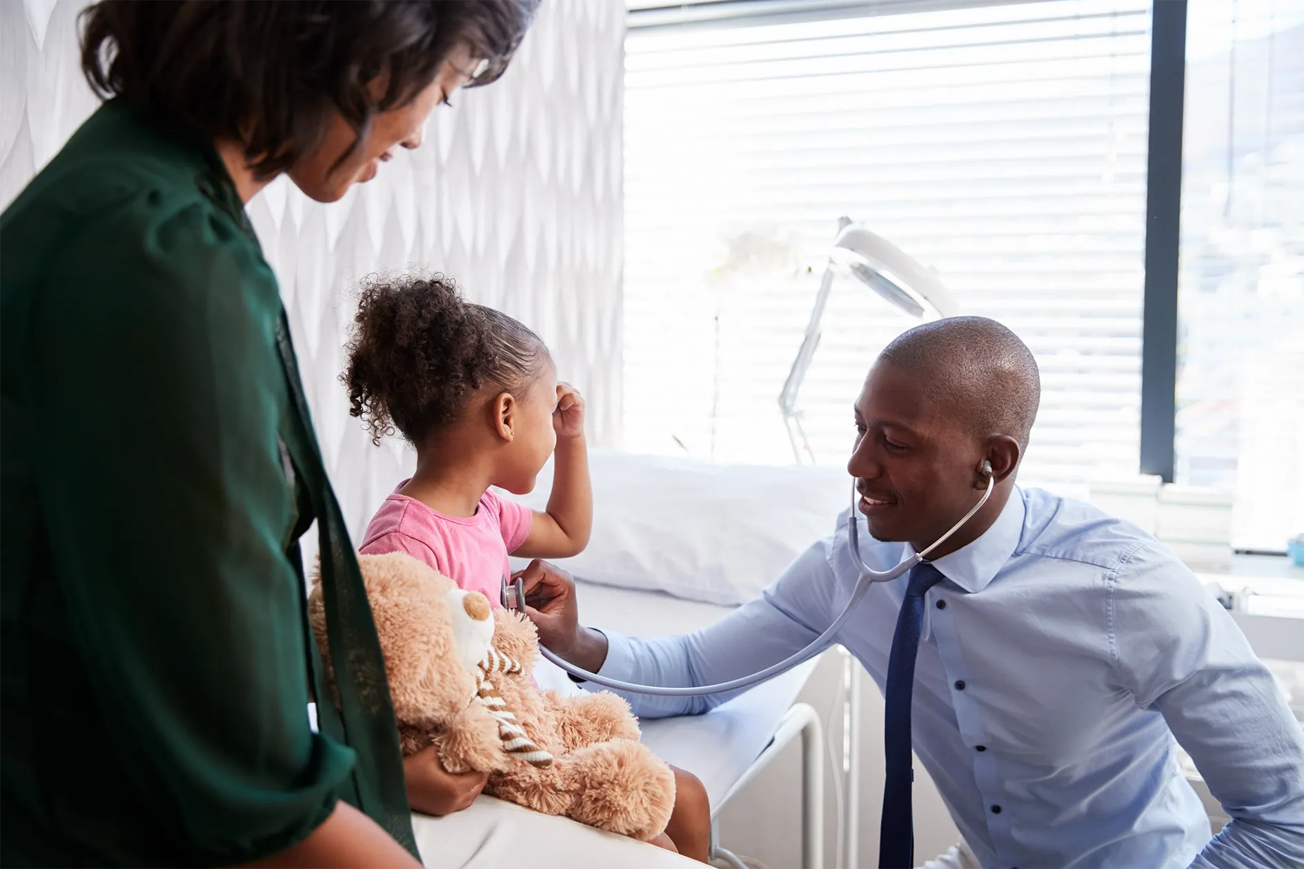 Mother and daughter with doctor